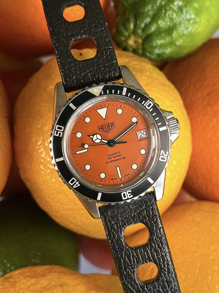 Heuer 1000 orange dial 980.014L on in front of fruit
