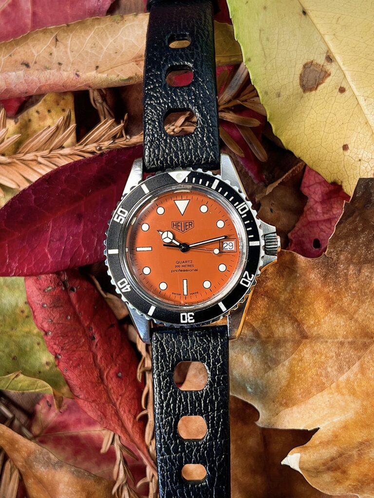 Heuer 1000 orange dial 980.014L on in front of autumn leaves